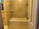 Neutral bathroom with tiled tub and light colored fixtures at 3794 W Hayward Ct, Tucker, GA 30084