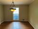 Bright dining room featuring hardwood floors and a classic light fixture at 3794 W Hayward Ct, Tucker, GA 30084