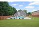 Expansive backyard featuring a swimming pool, lounge chairs, and lush green space, offering a perfect oasis at 5928 Edenfield Nw Dr, Acworth, GA 30101