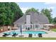 Spacious backyard with a swimming pool, comfortable seating, and a well-maintained lawn, perfect for relaxation at 5928 Edenfield Nw Dr, Acworth, GA 30101
