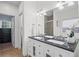 Bathroom with a double sink vanity, modern fixtures, and access to the walk-in closet at 5928 Edenfield Nw Dr, Acworth, GA 30101