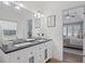 Bright bathroom with dual sinks, granite countertop, and view to bedroom at 5928 Edenfield Nw Dr, Acworth, GA 30101
