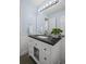Well-lit bathroom with granite countertop and decorative mirror at 5928 Edenfield Nw Dr, Acworth, GA 30101