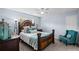 Cozy bedroom with a decorative wooden frame bed, comfortable seating, and natural light from the large window at 5928 Edenfield Nw Dr, Acworth, GA 30101
