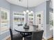 Cozy breakfast nook with a round table, four chairs, and views of the backyard pool through large windows at 5928 Edenfield Nw Dr, Acworth, GA 30101
