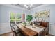Dining room featuring a large window, a modern chandelier, and stylish decor at 5928 Edenfield Nw Dr, Acworth, GA 30101