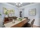 Dining room with a large table, modern chandelier, and stylish decor with a window view at 5928 Edenfield Nw Dr, Acworth, GA 30101