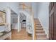 Foyer with staircase, hardwood floors, wainscoting, and view into the living and dining areas at 5928 Edenfield Nw Dr, Acworth, GA 30101