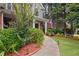 Charming two-story home featuring manicured landscaping, brick accents, and walkway to front door at 5928 Edenfield Nw Dr, Acworth, GA 30101