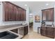 Kitchen with dark wood cabinets, granite countertops, stainless steel appliances, and tile flooring at 5928 Edenfield Nw Dr, Acworth, GA 30101