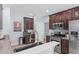 Well-equipped kitchen with stainless steel appliances, dark wood cabinets, and granite countertops at 5928 Edenfield Nw Dr, Acworth, GA 30101