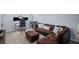 Spacious living room featuring a comfortable sectional sofa, an ottoman, and a well-organized workspace, great for relaxing at 5928 Edenfield Nw Dr, Acworth, GA 30101