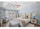 Main bedroom with a tray ceiling, ceiling fan, hardwood floors, and comfortable seating area at 5928 Edenfield Nw Dr, Acworth, GA 30101