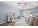 Comfortable main bedroom featuring a tray ceiling, ceiling fan, and a decorative dresser at 5928 Edenfield Nw Dr, Acworth, GA 30101