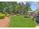 Beautiful backyard with a deck and lush landscaping, perfect for outdoor activities and relaxation at 2510 Wood Creek Ct, Dacula, GA 30019