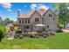 Manicured backyard with a spacious deck, patio furniture, and lush green lawn at 2510 Wood Creek Ct, Dacula, GA 30019