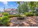 Relaxing backyard with a stone fire pit and lush landscaping; ideal for outdoor gatherings at 2510 Wood Creek Ct, Dacula, GA 30019