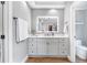 Bathroom featuring a vanity with a lighted mirror, modern fixtures, and a separate toilet room at 2510 Wood Creek Ct, Dacula, GA 30019