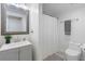 Clean bathroom featuring a gray vanity, framed mirror, and a shower with white curtain at 2510 Wood Creek Ct, Dacula, GA 30019