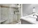 Modern bathroom featuring a glass-enclosed shower with bench, beautiful tile work, and a sleek vanity at 2510 Wood Creek Ct, Dacula, GA 30019