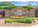 Stone clubhouse sign with lush landscaping welcomes residents and guests at 2510 Wood Creek Ct, Dacula, GA 30019