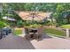 This outdoor deck features an umbrella, dining table, and furniture, perfect for entertaining at 2510 Wood Creek Ct, Dacula, GA 30019