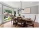 Bright dining room featuring large windows, hardwood floors, and stylish furnishings for elegant meals at 2510 Wood Creek Ct, Dacula, GA 30019