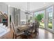 Sunlit dining room with a modern chandelier, hardwood floors, and large windows offering scenic views at 2510 Wood Creek Ct, Dacula, GA 30019