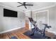 Well-equipped exercise room with workout machine, tv, and hardwood floors, offering a great space for fitness at 2510 Wood Creek Ct, Dacula, GA 30019