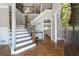 Elegant foyer with hardwood floors, a staircase with iron railings, and a view into the living room at 2510 Wood Creek Ct, Dacula, GA 30019