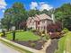 Beautiful brick home with lush landscaping and mature trees, complementing the serene neighborhood setting at 2510 Wood Creek Ct, Dacula, GA 30019