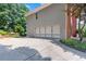 Spacious two-car garage with elegant doors and a paved driveway surrounded by landscaping at 2510 Wood Creek Ct, Dacula, GA 30019