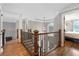 Elegant hallway with hardwood floors, detailed railing, and natural light, creating a welcoming transition space at 2510 Wood Creek Ct, Dacula, GA 30019