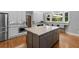 This spacious kitchen features a large island and modern stainless steel appliances, perfect for cooking and entertaining at 2510 Wood Creek Ct, Dacula, GA 30019