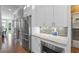 This kitchen shows modern stainless steel appliances, bright white cabinets, and lots of counter space at 2510 Wood Creek Ct, Dacula, GA 30019