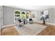 Sitting area with a light colored area rug, two chairs, and nice windows at 2510 Wood Creek Ct, Dacula, GA 30019