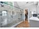 Luxurious main bathroom with a glass-enclosed shower, dual shower heads, and a walk-in closet at 2510 Wood Creek Ct, Dacula, GA 30019