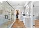 Luxurious bathroom with a glass-enclosed shower, vanity with dual sinks, and a walk-in closet at 2510 Wood Creek Ct, Dacula, GA 30019