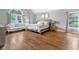 Spacious main bedroom with hardwood floors, large windows, and a comfortable seating area at 2510 Wood Creek Ct, Dacula, GA 30019