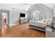 Expansive main bedroom featuring hardwood floors, vaulted ceilings, and a cozy seating area at 2510 Wood Creek Ct, Dacula, GA 30019