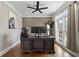 Home office featuring natural light, ceiling fan, and a large modern executive desk and chair at 2510 Wood Creek Ct, Dacula, GA 30019