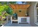Outdoor kitchen area featuring a grill, pizza oven, and counter space on a deck with a privacy screen at 2510 Wood Creek Ct, Dacula, GA 30019