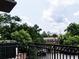 Scenic view from the balcony overlooking greenery, a building, and a cloudy sky at 3235 Roswell Ne Rd # 514, Atlanta, GA 30305