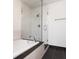 Modern bathroom featuring a bathtub with a glass shower enclosure and black tile floors at 3235 Roswell Ne Rd # 514, Atlanta, GA 30305