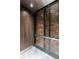 Modern elevator features brick accent wall and diamond plate flooring for a unique, stylish ride at 3235 Roswell Ne Rd # 514, Atlanta, GA 30305