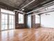 Spacious living room with exposed brick, floor to ceiling windows and hardwood floors at 3235 Roswell Ne Rd # 514, Atlanta, GA 30305