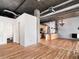 Open living area with hardwood floors, exposed ductwork, kitchen and adjoining bathroom at 3235 Roswell Ne Rd # 514, Atlanta, GA 30305