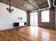 Exposed brick living room with a chandelier, ceiling fan, track lighting and hardwood floors at 3235 Roswell Ne Rd # 514, Atlanta, GA 30305