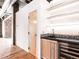 Stylish wet bar with sleek shelving, mosaic backsplash, and stainless steel wine fridge at 3235 Roswell Ne Rd # 514, Atlanta, GA 30305