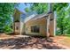 Back exterior of house shows an attached deck, yard, and mature trees at 3470 River Mill Ln, Ellenwood, GA 30294